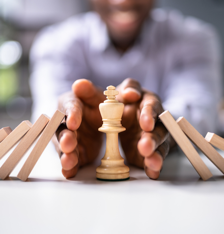 Risk management and transparency represented by a businessman safeguarding a chess piece